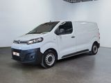the white van is parked in a large room with a ceiling fan
