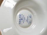 a white plate with a blue writing on it on a table