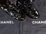 chanel shoes and a t - shirt are on display on the floor