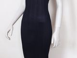 a mannequin wearing a black dress and hat on a mannequin head