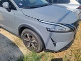 a silver car that is parked on the side of the road