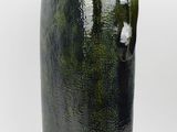 a green vase with a black handle on a white background
