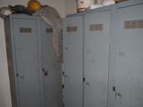 two lockers in the corner of a room with a lot of stuff on top of them
