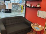 a couch and a table in a room with a red wall