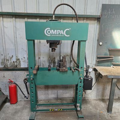 a green machine that is sitting in a garage