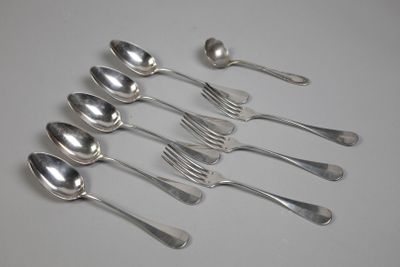six silver spoons and two silver spoons on a white surface