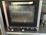 a toaster oven sitting on a counter in a kitchen
