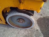 a close up of a wheel on a yellow machine