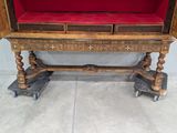 a wooden table with a red cushion on top of it