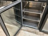 a glass door that is open to show the inside of a refrigerator