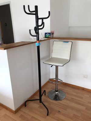 an image of a bar with a stool and a coat rack