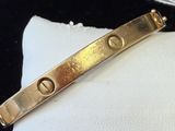 an image of a close up of a gold bracelet on a white cloth