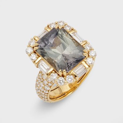a diamond and gold ring set with an emerald stone surrounded by baguets