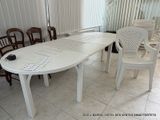 a white table and chairs in a room with blinds