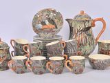 many cups and saucers that are sitting on a table