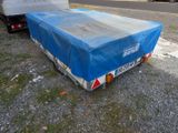 a blue tarp on the back of a truck