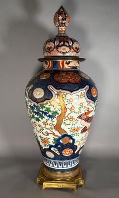 un vase muni d'un couvercle, posé sur un socle