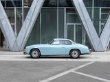 a blue car that is parked in front of a building