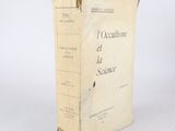 an old book sitting on top of a table next to a white wall
