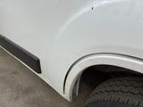 a close up of a white truck parked in a parking lot