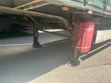 underside of a semi truck with a gas can attached to it