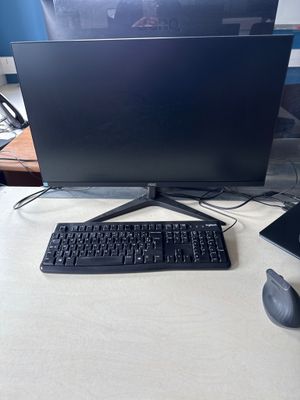 a keyboard, mouse, and monitor on a desk