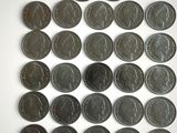 a lot of coins that are on a white surface