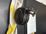 a black and white wall with a yellow and white towel hanging on it