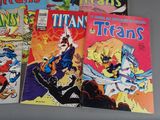 several comic books are lined up on a table
