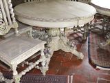 a table and chairs in a room with a rug on the floor