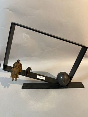 a mirror with a statue of a man and a dog on it