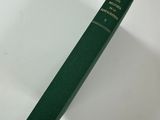 a green book sitting on top of a white table