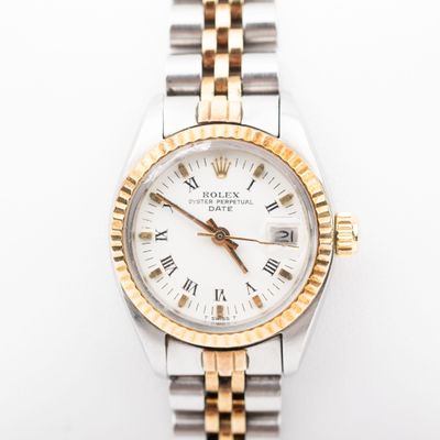 a close up of a wrist watch with roman numerals on it