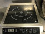 stainless steel counter top with a stove and a basket on top of it