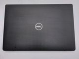 the dell laptop is sitting on a table with its lid open