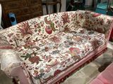 a couch with a floral pattern on it in a living room