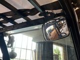 an image of a car ' s rear view mirror in a garage