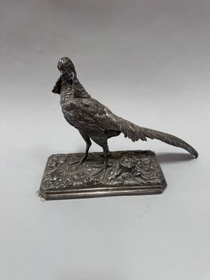a bird that is sitting on top of a silver plate