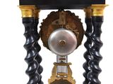 a black and gold clock with a bell on top of it