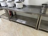 many pots and pans sitting on a stainless steel table