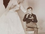 a vintage photo of a bride and groom feeding each other a piece of cake