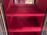 someone is taking a picture of a red cabinet with a mirror
