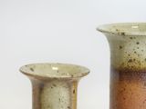 two vases sitting next to each other on a table