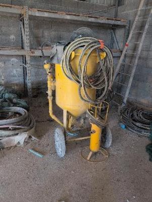 a yellow machine that is sitting in a garage