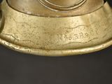a close up of a gold colored lamp on a black background