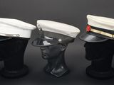 three hats are lined up on top of a mannequin head