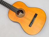 a guitar that is sitting on a white surface