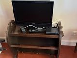 a television sitting on top of a wooden table