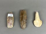 three different types of rocks on a gray surface