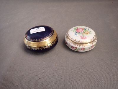 pair of porcelain boxes with floral designs on them sitting on a table